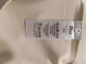 Dior clothing garment tag size M made in France beige fabric care instructions label