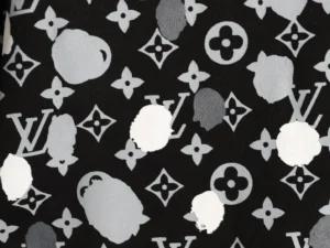 Yayoi Kusama-inspired Louis Vuitton hoodie fabric featuring hand-drawn polka dots, iconic LV logos, and a black background, showcasing luxury fashion design elements.