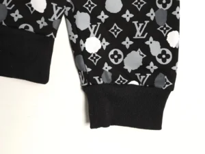 Louis Vuitton hoodie sleeve featuring Yayoi Kusama's hand-drawn polka dot pattern and iconic LV monogram design.
