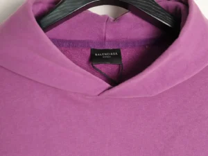 Balenciaga Classic Cola Seal hoodie in vibrant purple, featuring a hood and label, highlighting premium cotton fabric and stylish design.