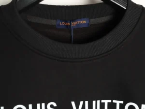 Black Louis Vuitton hoodie collar with logo tag, featuring prominent white text.