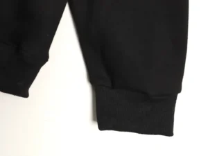 Black hoodie sleeve cuff detail showcasing premium fabric and design, related to Louis Vuitton hoodie product listing.