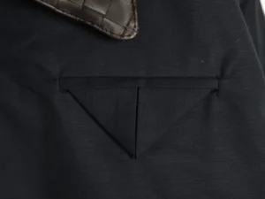 Prada nylon black bag with brown leather details close-up of fabric and stitching