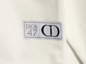 DIOR 47 label on a round neck guard, showcasing luxury fashion branding for men and women.