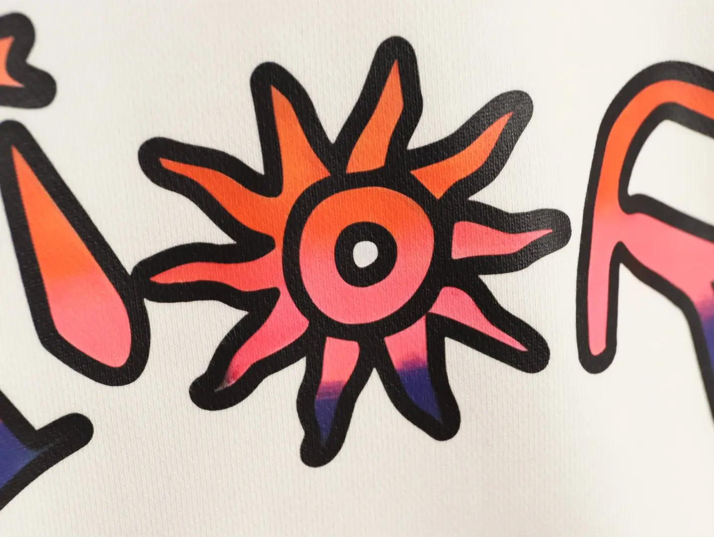 Colorful graphic design featuring a sunburst motif in shades of orange and pink, part of the DIOR 47 Letter Round Neck Guard, highlighting the trendy and stylish elements of the apparel.