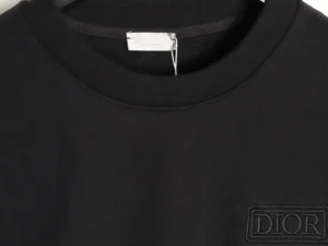 Close-up of a black DIOR letter embroidered round neck sweatshirt, highlighting the fabric texture and logo detail.