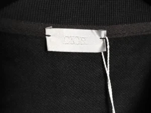 DIOR label on a black round neck sweatshirt, showcasing fabric quality and brand identity.