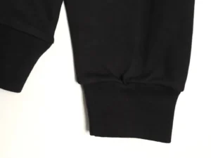 Close-up of the cuff of a DIOR letter embroidered round neck sweatshirt, showcasing the fabric quality and design details.