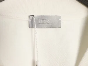DIOR logo tag on a round neck sweatshirt, showcasing luxury fashion details and quality craftsmanship.