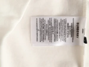 Burberry clothing label white fabric 100% cotton outer shell viscose and polyamide lining
