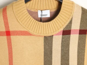 Burberry plaid patchwork stripes knitted sweater featuring a ribbed neckline and multicolored fabric sections, showcasing quality craftsmanship and design details.