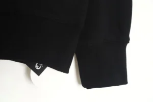 Black Chrome Hearts hoodie featuring a logo tag on the hem, showcasing premium craftsmanship and stylish design.