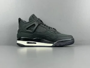 Jordan 4 RM SP Nigel Sylvester Driveway Grey sneaker featuring a sleek black upper, mesh panels, and white midsole, showcased against a neutral background.