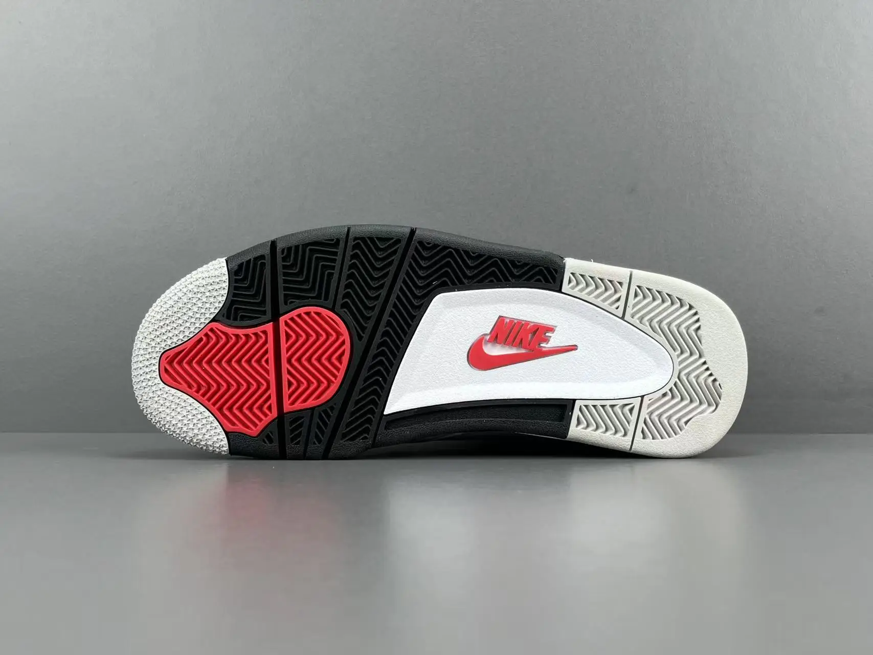 Nike Air Jordan 4 Retro OG black white red rubber outsole sneakers with Nike logo