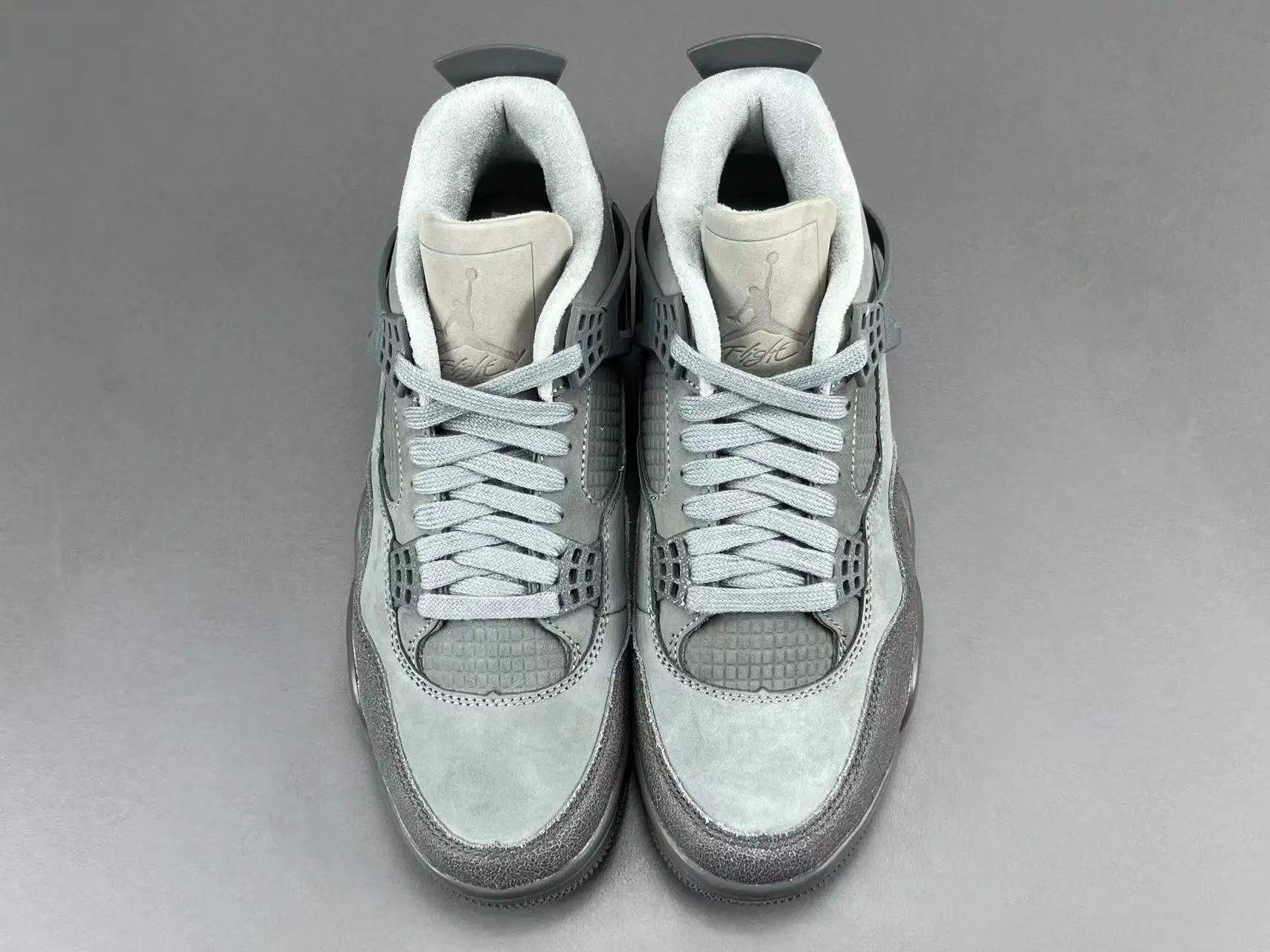 Air Jordan 4 Taupe Haze light grey suede sneakers with mesh panels and rubber sole