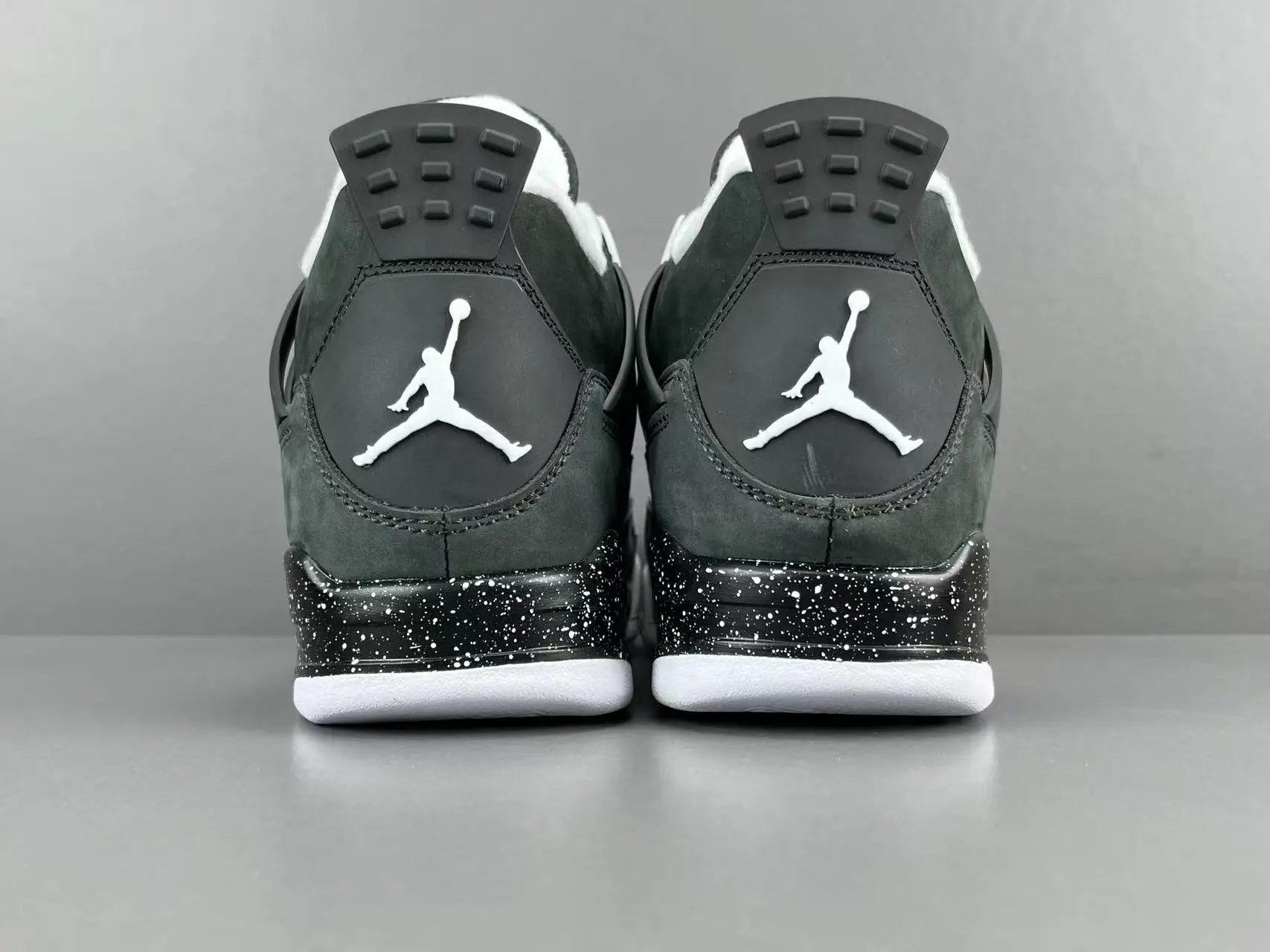 Nike Air Jordan 4 Retro black white speckled midsole suede sneakers back view