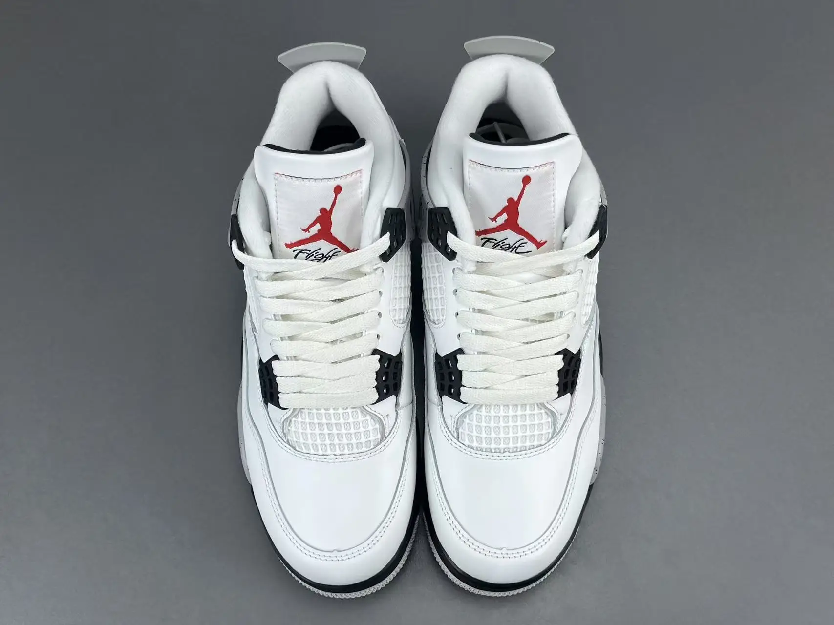 Nike Air Jordan 4 OG white red black leather sneakers with mesh detailing and plastic eyelets