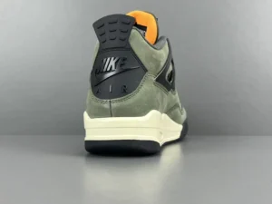 Nike Air Jordan 4 sneakers in green and black colorway, showcasing the heel with prominent Nike branding and a sleek design.