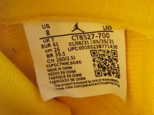 Nike Air Jordan 1 Low CT8527-700 yellow leather sneakers with size US 8 tag closeup