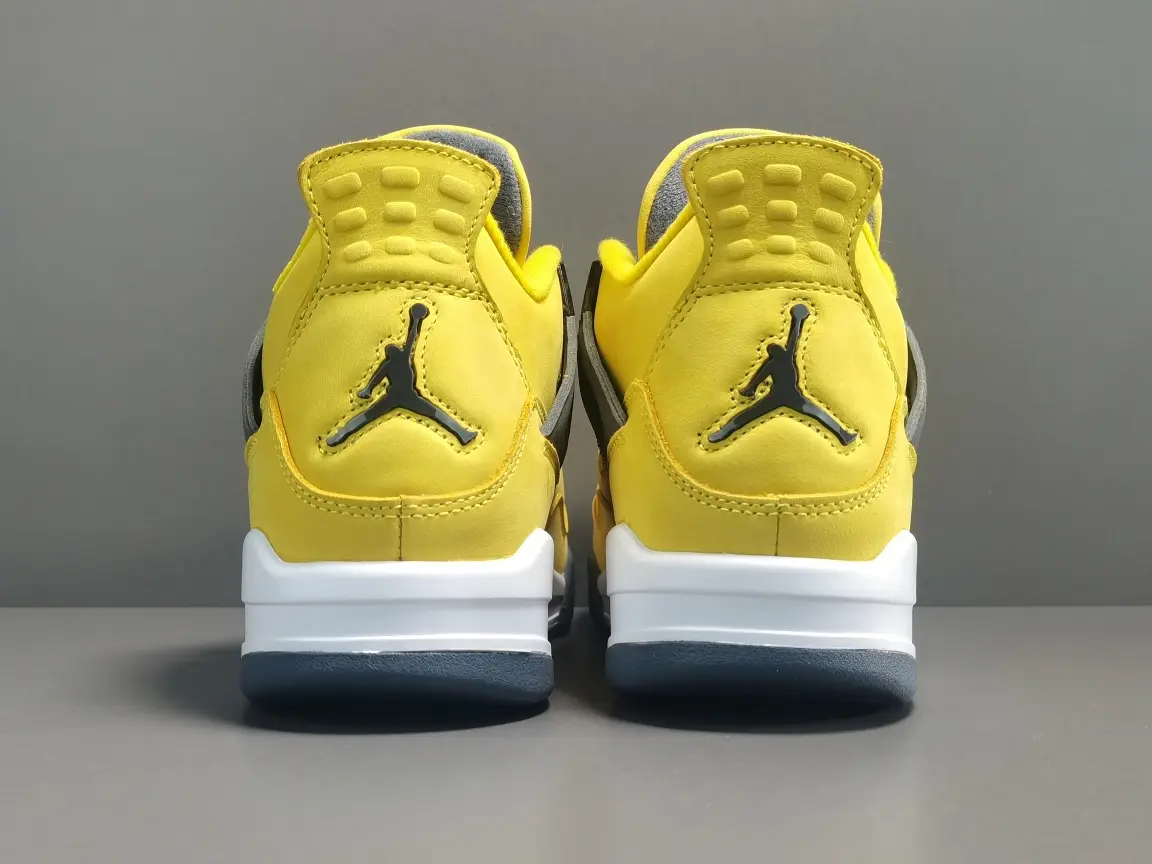 Nike Air Jordan 4 Lightning yellow black white leather sneakers with mesh detailing and rubber sole