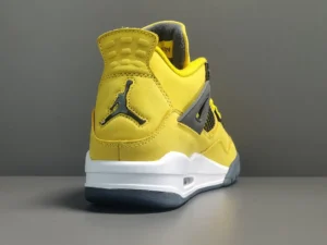 Nike Air Jordan 4 Lightning yellow black white leather sneakers with mesh detailing and rubber sole