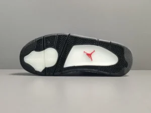 Air Jordan 4 Retro Travis Scott Cactus Jack sneaker sole featuring black rubber outsole and red Jumpman logo, emphasizing design and quality for sneaker enthusiasts.