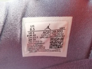 Air Jordan 4 Retro Canyon Purple sneaker label showing size, product code AQ9129-500, and manufacturing details.