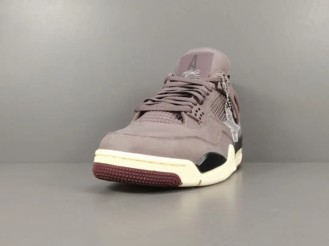 Jordan 4 Retro SP A Ma Maniére Violet Ore sneaker featuring a gray upper, mesh panels, and signature branding, displayed on a neutral background.