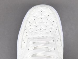Louis Vuitton LV Trainer sneaker white embossed leather luxury footwear close-up top view