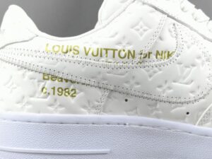 Nike Air Force 1 Low x Louis Vuitton white leather sneakers with embossed monogram and gold lettering details
