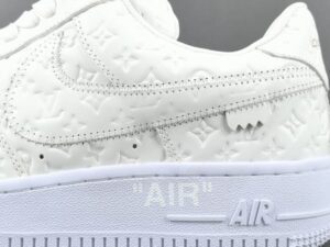 Nike Air Force 1 Low white embossed leather sneakers with stitched swoosh and "AIR" sole detailing