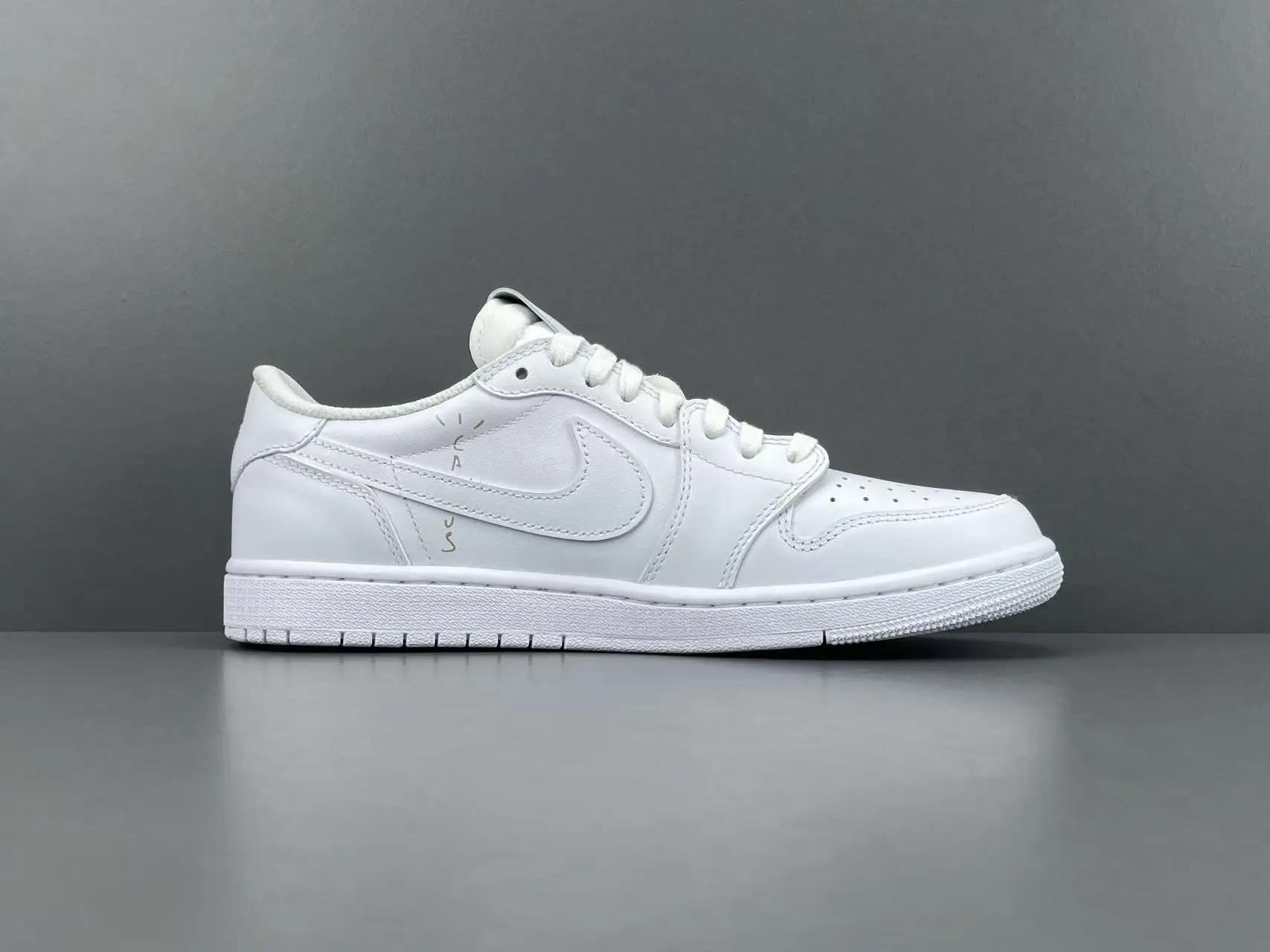 Nike Air Jordan 1 Low white colorway full leather sneakers with subtle black text detail on side panel