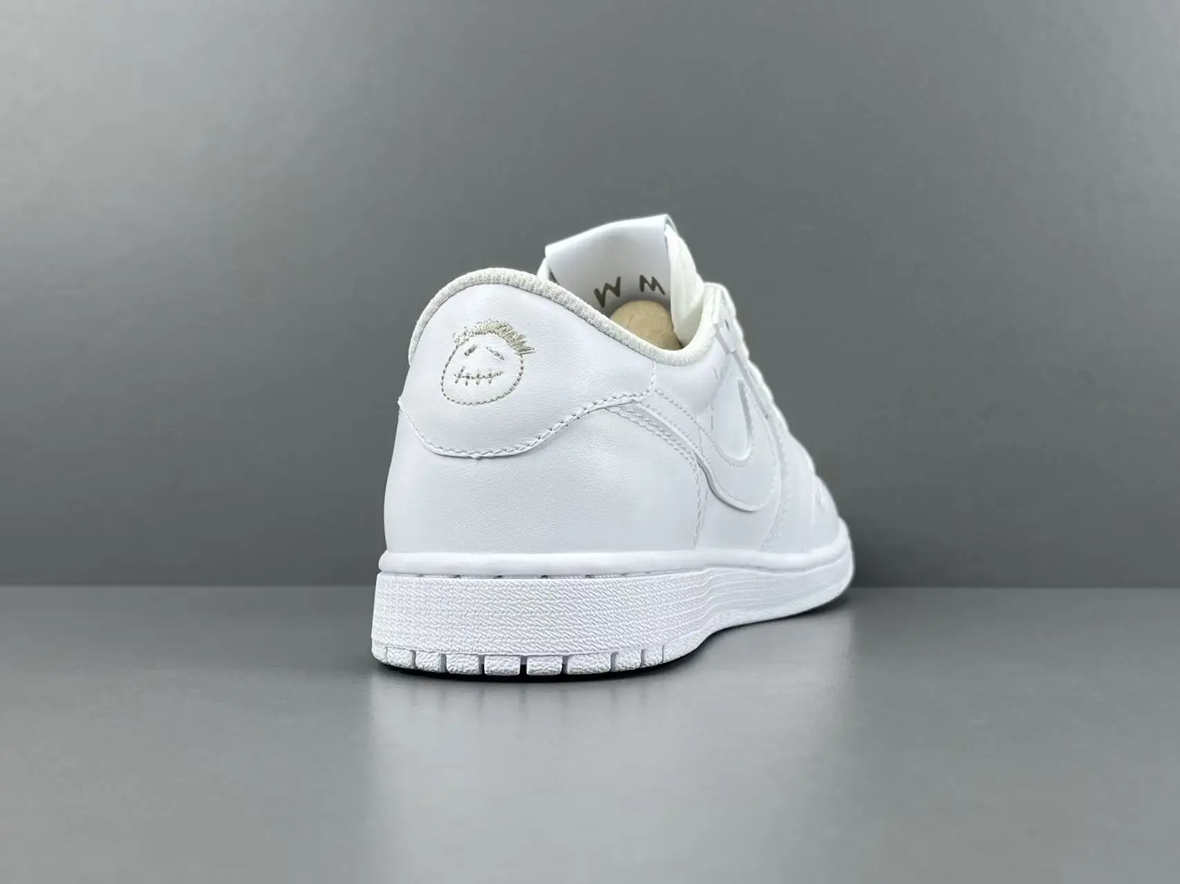 Nike Air Jordan 1 Low OG white colorway leather sneakers with embroidered heel logo and white sole