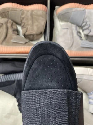 Yeezy Slide Core black EVA foam sandals with textured footbed and smooth strap design