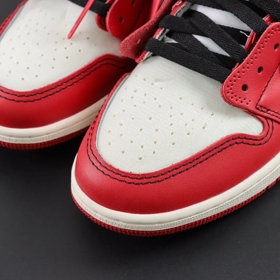 Nike Air Jordan 1 Retro OG white red black leather sneakers with perforated toe box and black laces